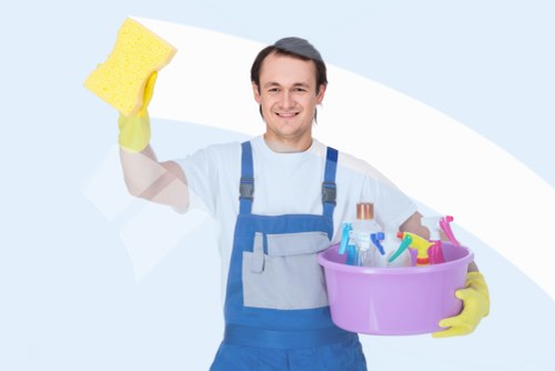 After builders cleaning removing dust from a renovated room