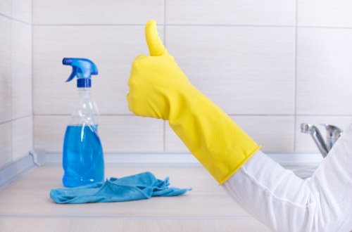 Technician cleaning a dirty oven interior with safe tools