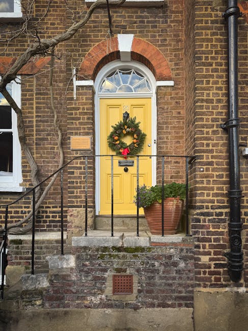The image depicts a three-story red brick building with white-framed windows and architectural decorative elements, located on a street corner in West Hampstead. The ground floor features a bakery, ca